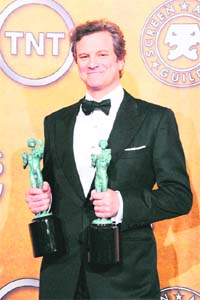 Colin Firth holds awards for best actor and ensemble for The King's Speech at the 17th Annual Screen Actors Guild Awards