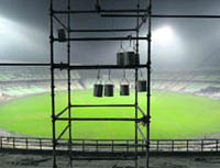 Paint containers hang in a stand under construction at Eden Gardens Stadium in Kolkata on Monday. 