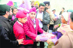 Students of St Francis School distribute clothes among women in Amritsar Central Jail. 