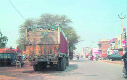 Vehicles laden with construction material parked along the Baltana link road