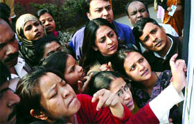 Parents of nursery children scanning an admission list in one of the schools in New Delhi on Tuesday.