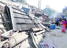 Illegal shops being demolished by the administration at the Tehsil Chowk.