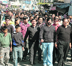 Traders take out a protest march against the demolition in Dehradun on Tuesday.