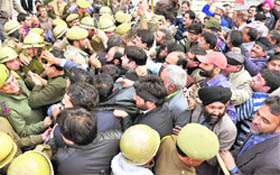 Government employees clash with the Jammu police during a protest in Jammu on Monday. 