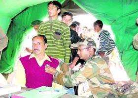 An Army doctor examines patients at a medical camp in Sunderbani