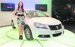 A model at the launch of Marutis luxury sedan Kizashi in New Delhi on Wednesday. The car will be available in two variants, a manual transmission priced at Rs 16.5 lakh and the automatic version at Rs 17.5 lakh. 