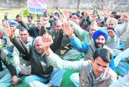 Teachers stage a protest outside the DEOs office at Sector 7, Panchkula,on Wednesday. 