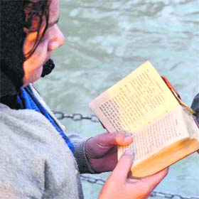A devotee reads the Gita at the Har-ki-Pauri in Haridwar