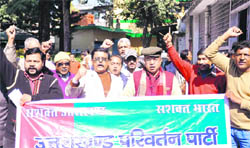 Workers of the Uttarakhand Parivartan Party hold a demonstration before submitting a memorandum to the District Magistrate in Dehradun