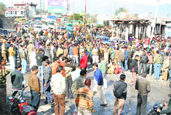 Protesters block the national highway at Udhampur on Wednesday over the murder of two MES employees .