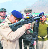 A CRPF officer demonstrates how to use a latest Israeli weapon X95 5.56 mm during a seminar organised to train the security forces to deal with law and order situations, at the CRPF base camp in Srinagar on Wednesday.