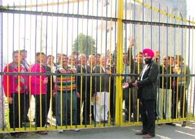 Residents stage a protest against locking of the New Kitchlu Nagar’s gate in Ludhiana