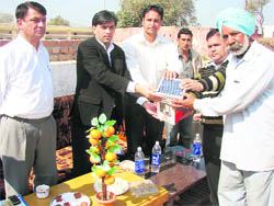 ADC Ashok Meena gives away a solar lamp to a Boswal resident in Fatehabad on Thursday.
