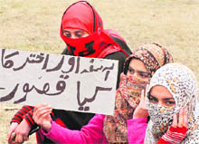 Women protest in Srinagar on Thursday against the killing of two sisters by suspected militants in Sopore