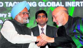 Warm welcome: Prime Minister Manmohan Singh shakes hands with President of Afghanistan Hamid Karzai in New Delhi on Thursday.
