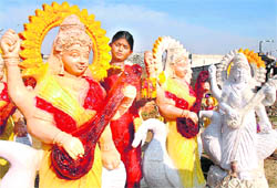 A Rajasthani artiste gives the finishing touches to a statue of Goddess Saraswati in Bawa Basti Khel in Jalandhar