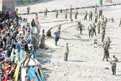 Soldiers stand between protesters (left) and pro-government supporters (unseen) in Tahrir square
