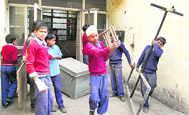 Schoolchildren made to lift ladder, boxes and other heavy things in Amritsar.