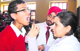 Dr Navdeep Singh and Dr Ishtpreet Kaur inspect students during a dental check-up camp at DAV Senior Secondary School in Amritsar.