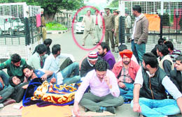 Panjab University students block the office of the Vice-Chancellor, RC Sobti (encircled), as he looks on, in Chandigarh on Friday