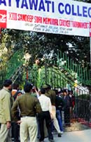 Officials of the Delhi police outside Satyawati College in New Delhi on Friday.