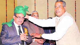 Dr Gorakh Singh, Horticulture Commissioner, being honoured with a turban at a seminar in Karnal on Friday.