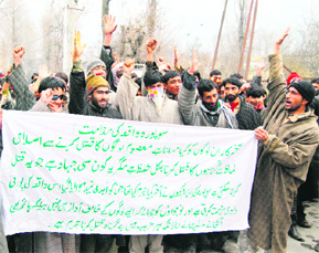 Residents protest in Srinagar on Friday against the killing of two sisters in Sopore.