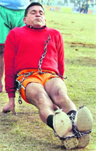 Sahib Singh, a resident of Jalandhar, breaks a chain.