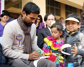 Cricketer Mohammed Kaif gives an autograph to a child at the sports complex, Sector 12, Faridabad on Saturday.