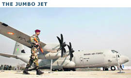 A soldier walks past the C-130J-30 Super Hercules Aircraft during an induction ceremony at Hindan Air Force Station in Uttar Pradesh on Saturday.
