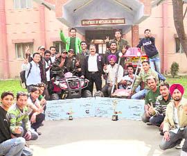 Students of the Sant Longowal Institute of Engineering and Technology, along with the faculty adviser, show an all-terrain vehicle designed by them.