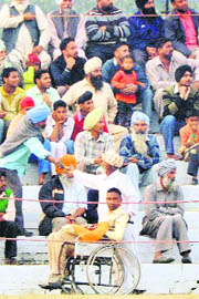 Kuldeep Singh Keepa, a kabaddi player whose spinal chord was ruptured while playing a match three years ago, seeks donations at Kila Raipur games on Saturday.