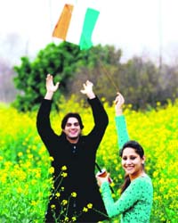 A couple flies a kite on the eve of Basant Panchami near Chandigarh