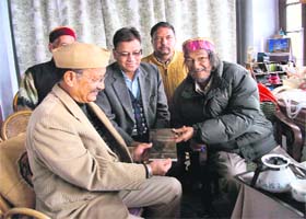 Sudhir Thapliyal presents his book Mansoori Macabre to former Chief Minister BC Khanduri in Mussoorie