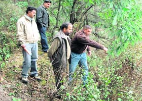 A member of the Garden Welfare Associaton shows a landslide-prone area to Upendar Thapli, Mandi Parishads former vice-president, in Mussoorie