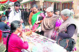 Women enquire about products displayed by women entrepreneurs at an annual fair in Dehradun on Sunday