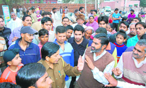 Residents block the national highway in protest against choked sewers in Sirsa on Sunday. 