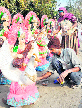 Artistes give the final touches to a statue of Goddess Saraswati in Karnal on Saturday. Tribune photo: Ravi Kumar