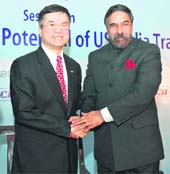 Trade Minister Anand Sharma (R) shakes hands with US Commerce Secretary Gary Locke during a session on "Unlocking the Potential of US-India Trade" in New Delhi on Monday.