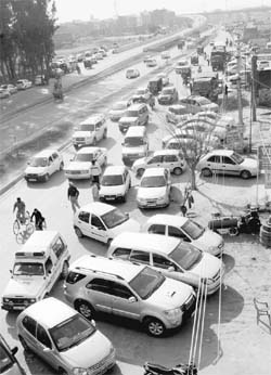 Haphazardly parked vehicles along the Zirakpur-Kalka highway outside a marriage palace in Zirakpur on Sunday.