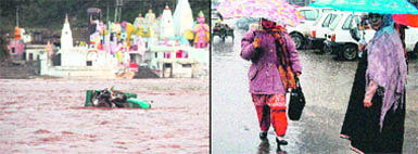 A load-carrier trapped in a flash flood in the Tawi opposite the Hari Ki Pouri temple in Jammu on Monday; and (right) women walk with umbrellas in heavy rain in Srinagar. 