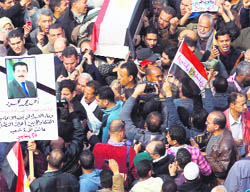 Egyptian anti-government demonstrators stage a symbolic funeral for colleague Ahmed Mahmud (picture), killed during clashes with pro-government supporters, at Tahrir Square on Monday.