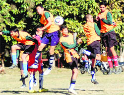 Players jump to head the ball in a match of the Narayan Gurung Zics Memorial Football Tournament in Dehradun on Tuesday