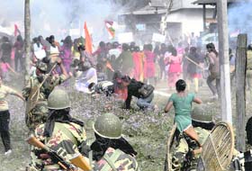 Security men chase away Gorkha Janmukti Morcha supporters during a clash following the dismantling of a GJM camp at Sibchu in Jalpaiguri district on Tuesday