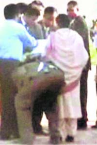 UP CM Mayawati's security officer cleans her shoes during her visit to Auraiya