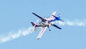 An aerobatic team displays its skills on the eve of the Aero India- 2011 at Yelhanka Air Force Station in Bangalore