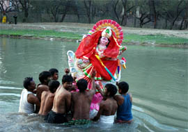 Devotees immerse the idol of Goddess Saraswati in the Sirhind canal in Bathinda on Wednesday.