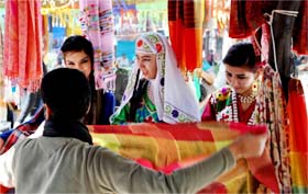 Foreigners shop at a stall in Surajkund Crafts Mela in Faridabad
