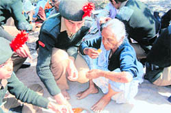NCC cadets give food to a poor woman at the YWCA Old Age Home in Dehradun on Tuesday.