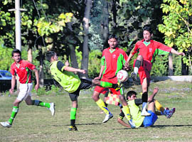 Players vie for the ball in a match of the 19th Narayan Gurung Zics Memorial Football Tournament in Dehradun on Wednesday.